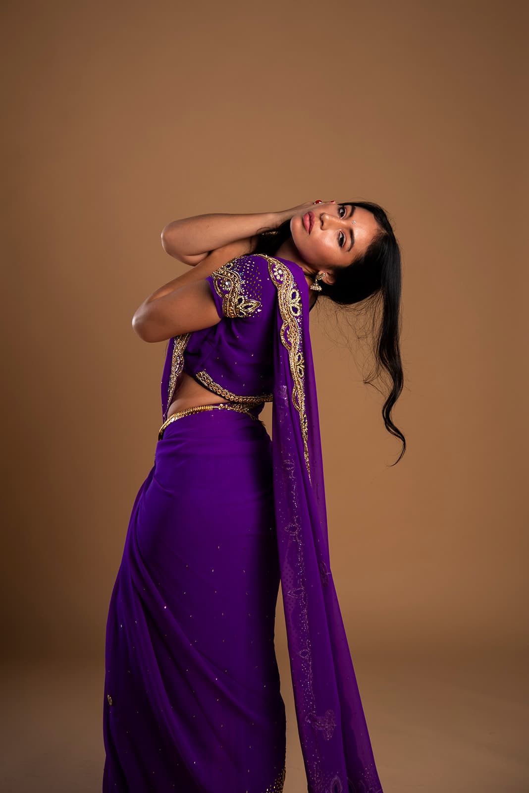 Vinodini Dasi in a purple sari, looking toward the light.